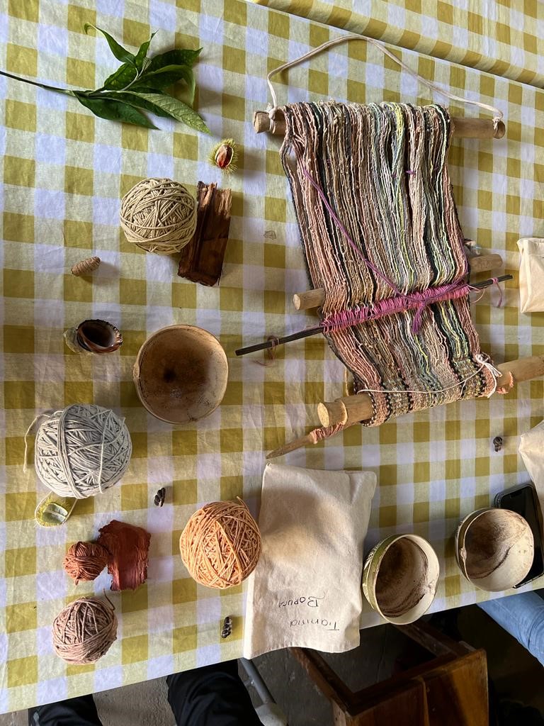 Table showing weaving tools and various wool