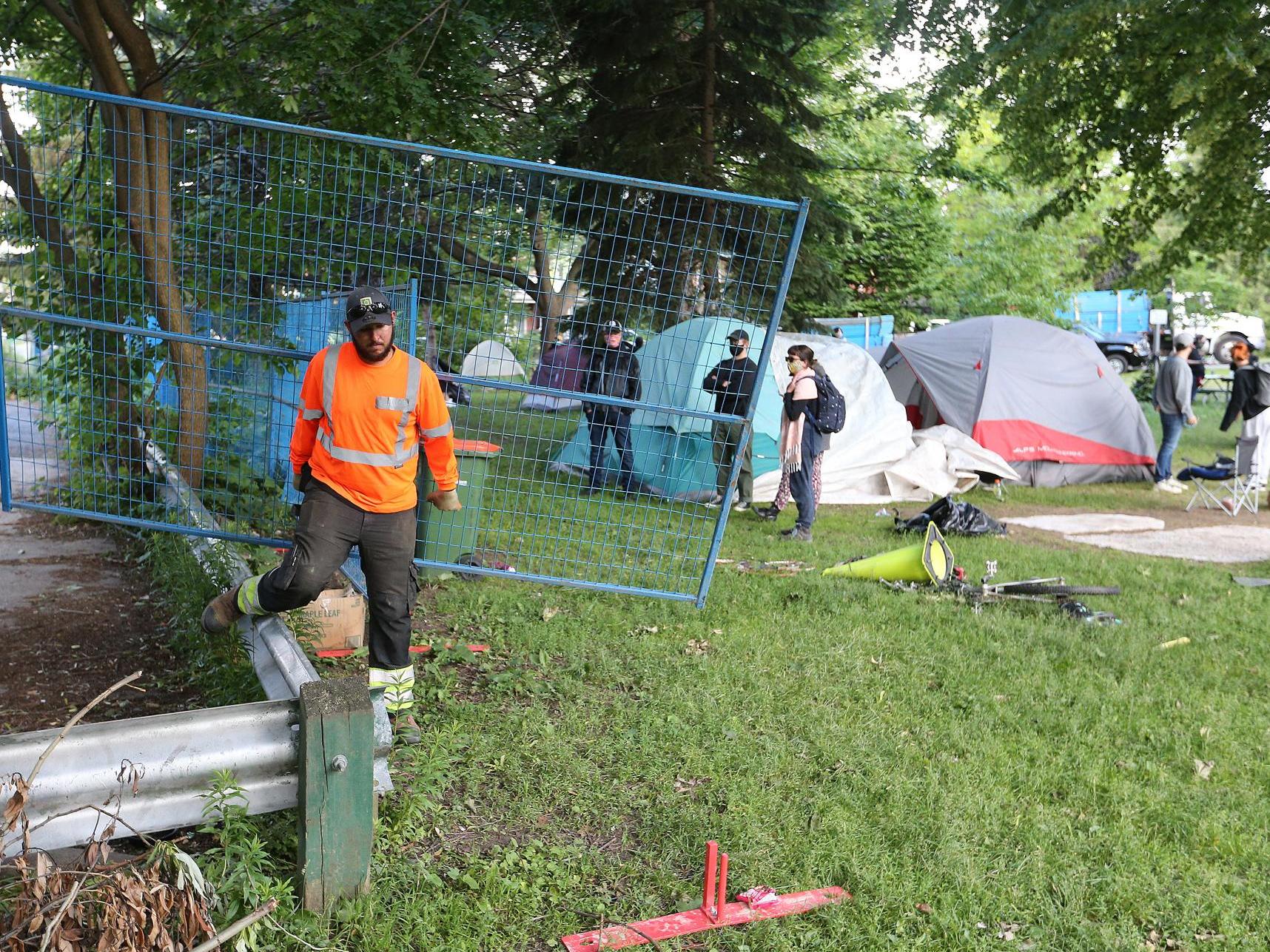 A city employee at a homeless encampment in Toronto