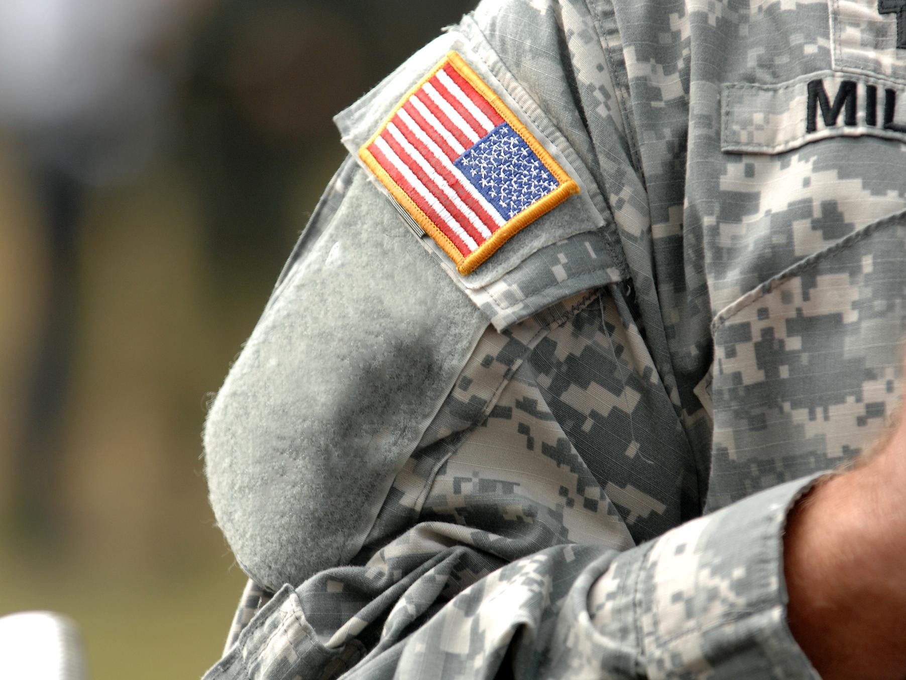 A close up of a US flag patch on a soldier's sleeve