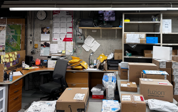 The storeroom at UTSC with a staff member's desk on the left of the image