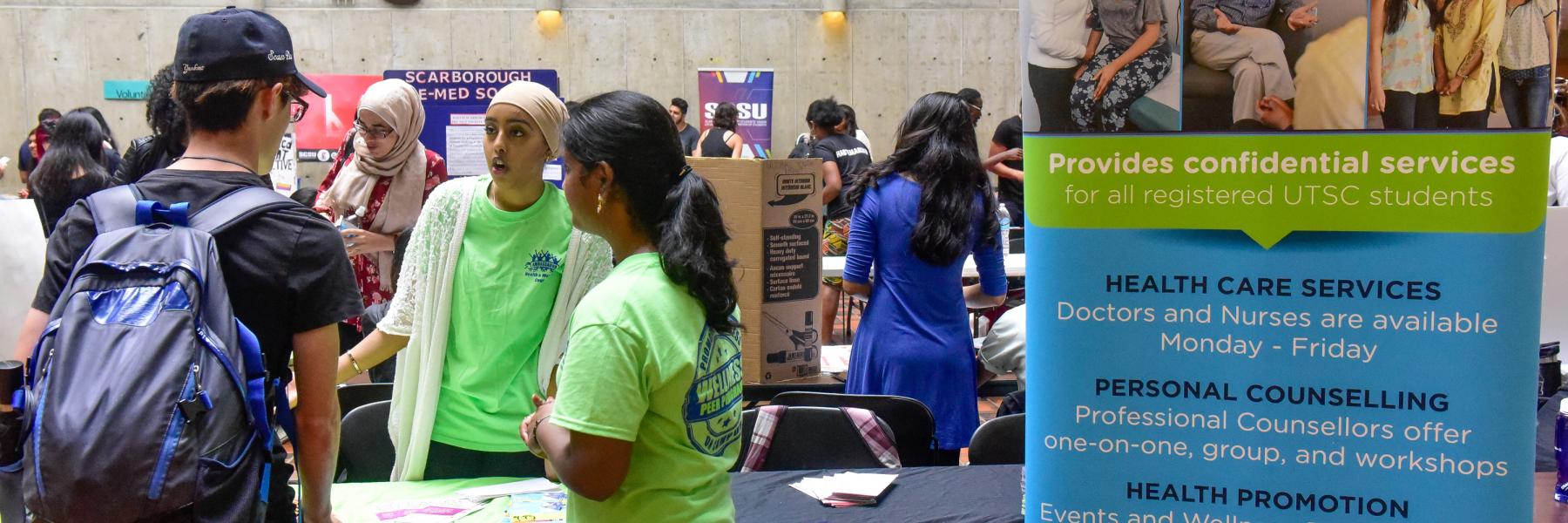 Group of students at a Health and Wellness information booth 