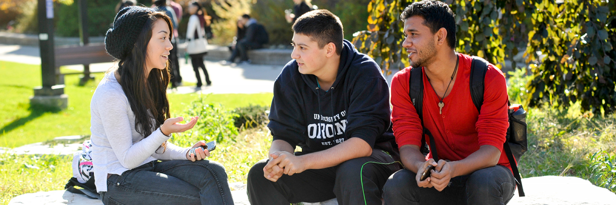 Three students talking outside